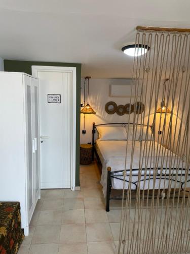 a bedroom with a bed and a hanging hammock at Kastraki Sea View in Tolo
