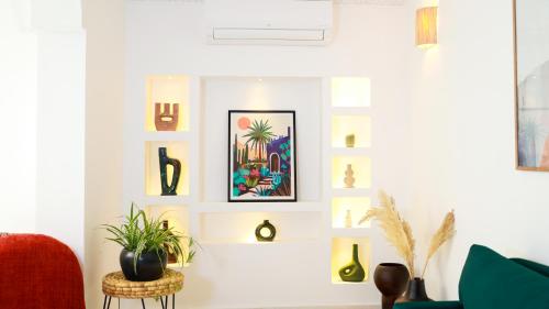 a living room with art on the wall at Riad Reflet D'orient Marrakech in Marrakech