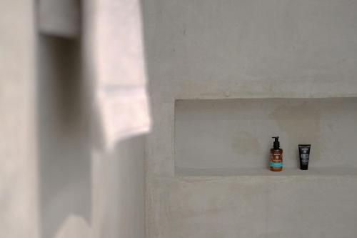 a bottle of alcohol sitting on a shelf in a wall at Scirocco Luxury Villas & Suites in Vasiliki