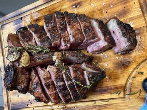 a wooden cutting board with meat on it at Seehotel Riviera at Lake Lucerne in Gersau