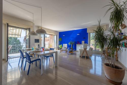 a dining room and living room with a table and chairs at Blue Dream in Ispra