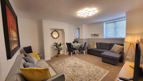 a living room with a couch and a table at St Michaels Town House - Elegant and Large Holiday Home in the Heart of Gloucester in Gloucester