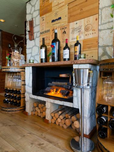 a bar with a fireplace with bottles of wine at Seehotel Riviera at Lake Lucerne in Gersau