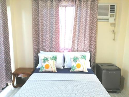 Ένα ή περισσότερα κρεβάτια σε δωμάτιο στο Solsken Guest House - Bantayan Island