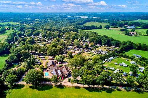an aerial view of a village with houses and trees at Vakantiepark het Wieskamp in Henxel