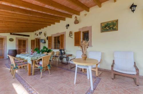 a dining room with a table and chairs at NEW! Villa Cas Padrins By BeBreeze for 7 with Pool and Mountain Views - Els Niguls in Lloseta