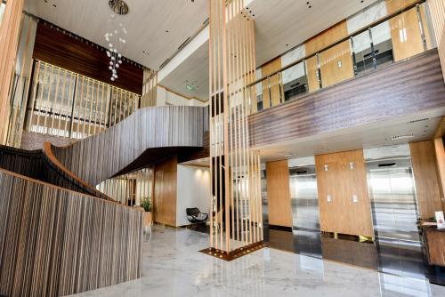 a lobby with a staircase in a building at Lovina 31-ABAC at One Residence near Ferry Terminal in Pulau Sembakau Kecil