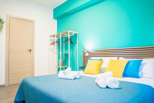 a blue bedroom with a bed with towels on it at Dodo's house in Bari