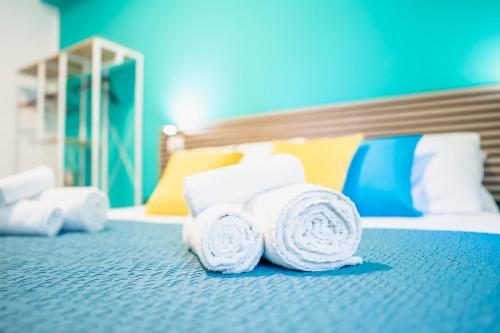 a pile of rolled towels on a bed at Dodo's house in Bari
