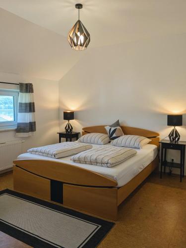 a bedroom with two beds and a chandelier at Stop & Sleep - Private Rooms in Ybbs an der Donau