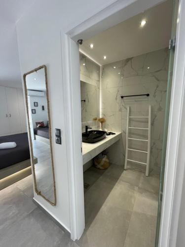 a bathroom with a mirror and a sink at Zoumis Residence in Naousa