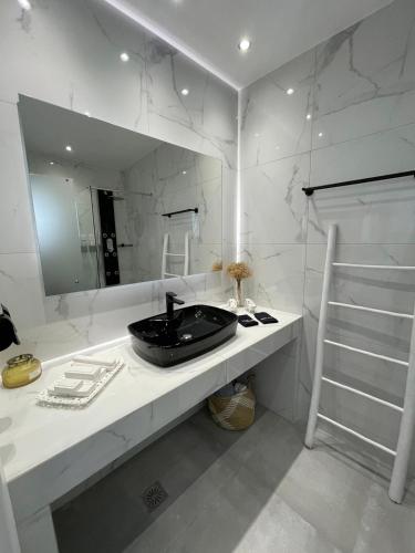 a bathroom with a black sink and a mirror at Zoumis Residence in Naousa