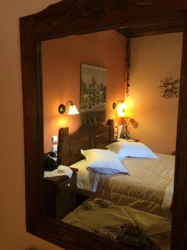 a bedroom with a large mirror and a bed at Archontiko Tsiboni in Elati Trikalon