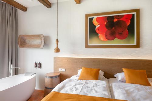 a bathroom with two beds and a bath tub at Hiša Marija House in Miklavž pri Ormožu