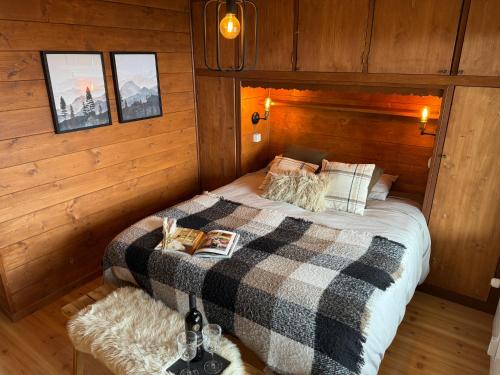 a bedroom with a bed in a wooden cabin at Verbier 2 bedrooms apartment- Scenic view - 6 Pax in Verbier