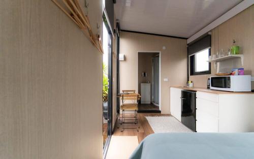 a kitchen with a counter and a microwave in a room at Weka Pass Cottages 4 by Tiny Away in Waikari