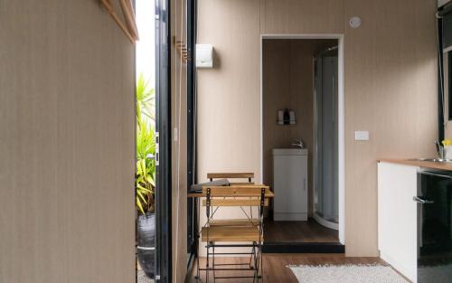 a room with a table and a desk with a chair at Weka Pass Cottages 4 by Tiny Away in Waikari