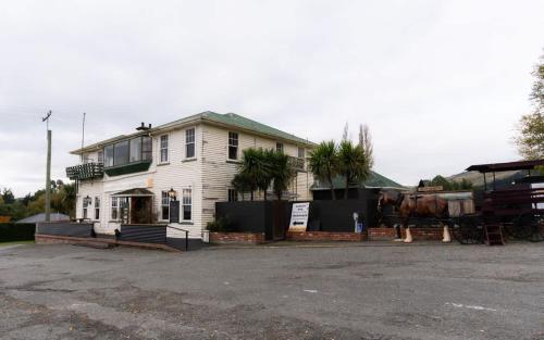 a horse is standing in front of a house at Weka Pass Cottages 4 by Tiny Away in Waikari