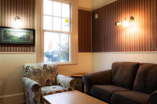 a living room with a couch and a table and a window at Weka Pass Cottages 4 by Tiny Away in Waikari