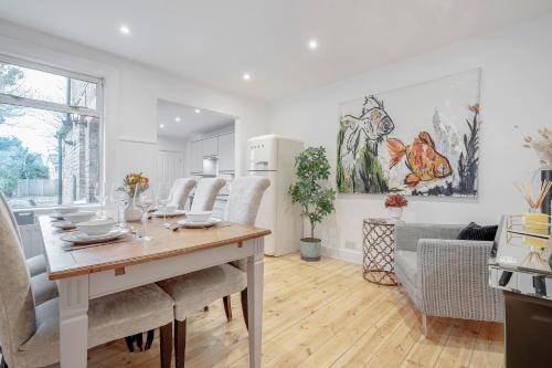 a kitchen and living room with a table and chairs at New 3 Bed Victorian Dream House in Staines