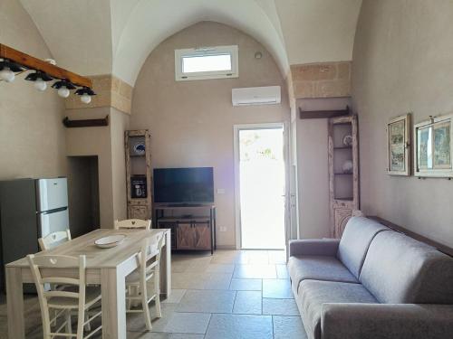 a living room with a couch and a table at Le 2 Volte in Carmiano