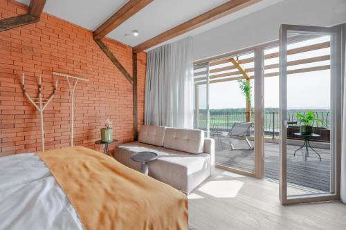 a bedroom with a bed and a brick wall at Hiša Marija House in Miklavž pri Ormožu