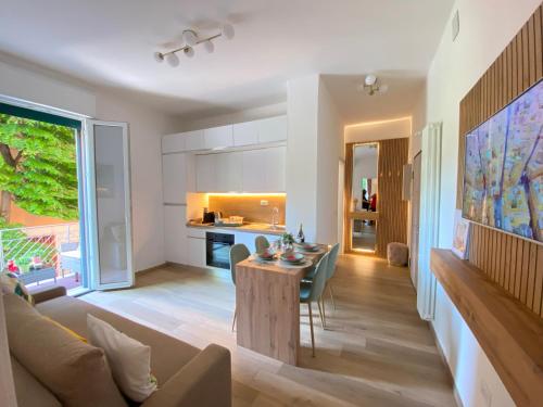 a living room and kitchen with a table and a couch at Sant'Orsola Lodge Bologna in Bologna