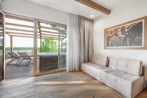 a living room with a couch and a balcony at Hiša Marija House in Miklavž pri Ormožu