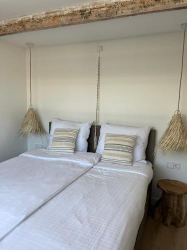 two beds in a bedroom with two pillows at BeachHouse ibiza 19A in Noordwijk aan Zee