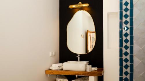 a bathroom with a sink and a mirror at Riad Reflet D'orient Marrakech in Marrakech