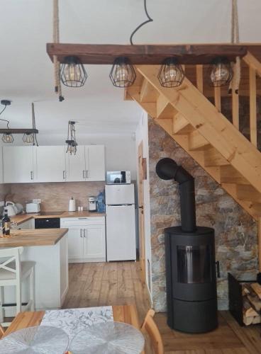 a kitchen with a wood stove in a room at Domek na Czerwonej Górce in Uście Gorlickie
