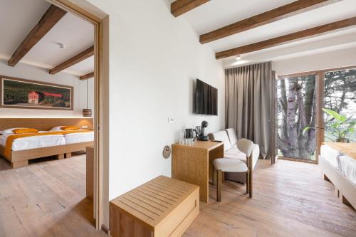 a bedroom with two beds and a desk with a desk at Hiša Marija House in Miklavž pri Ormožu