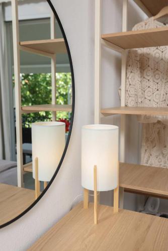a mirror and two white chairs in a room at Anastasia Studios Hanioti in Hanioti