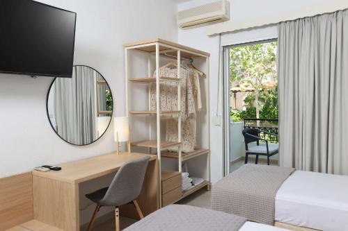 a bedroom with a desk and a bed and a mirror at Anastasia Studios Hanioti in Hanioti