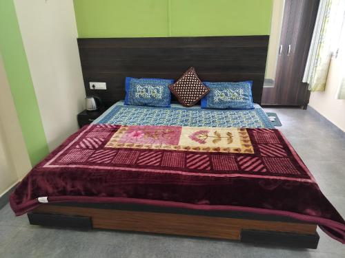 a bedroom with a large bed with a red blanket at Tree Valley Homestay Chail in Chail