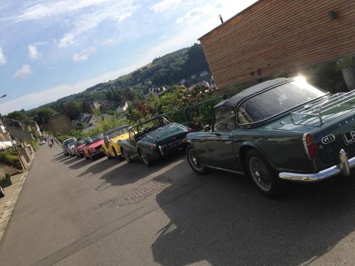 a row of cars parked on the side of a road at Hotel Cosy Bouillon in Bouillon