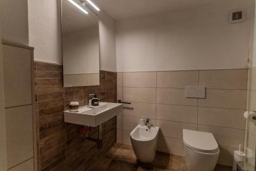 a bathroom with a sink and a toilet at Sardinian Gallery Domus in Bosa