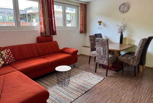 a living room with a couch and a table at Hotel Garni Wolfgang in Saalbach Hinterglemm