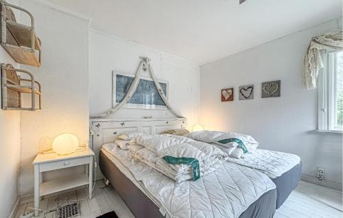a white bedroom with a bed and a window at 3 Bedroom Awesome Home In Stöllet in Stöllet