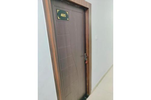 an elevator door with a time sign on it at Hotel Patna Sahib Inn in Patna