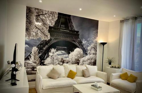 a living room with a large painting of the eiffel tower at PARIS CITY-Le Raincy - Facing station - 4 to 8 Pers in Le Raincy