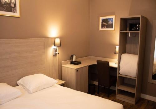 a hotel room with two beds and a desk and a desk at Paris Rooms & Dreams Hotel in Paris