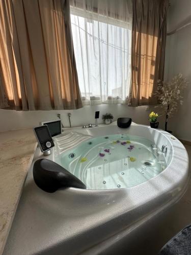 a large bath tub in a room with a window at Luxury Panorama pyramids & jacuzzi in Cairo
