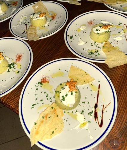 a group of plates with food on them on a table at La Fattoria Delle Tartarughe in San Gregorio