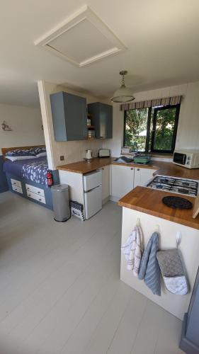 a small kitchen with a bed in a room at Lynstone Lakes in Bude