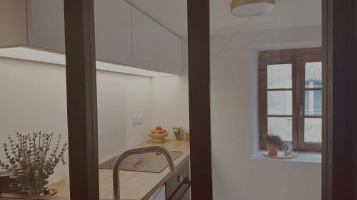 a kitchen with a sink and a window at La Maison de Victoire et Alix in Pontrieux
