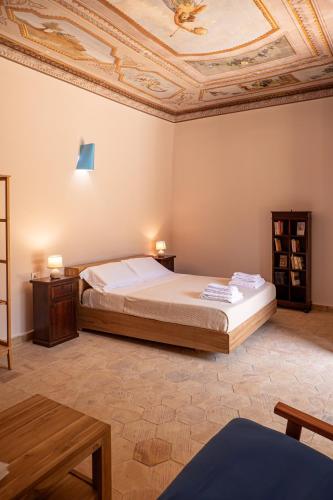 a bedroom with a bed and a coffered ceiling at Villa Amoroso - Ospitalità Mediterranea in Agrigento