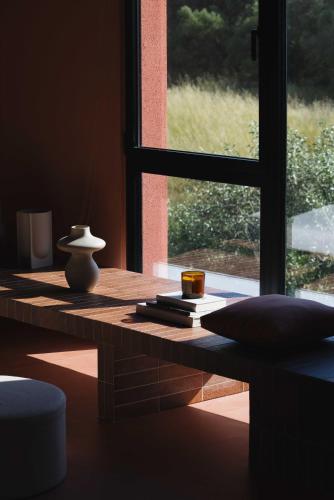 a window sill with a table with a vase on it at AKTI SEASIDE SUiTES in Preveza