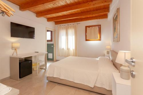 Postel nebo postele na pokoji v ubytování B&B Pettirosso