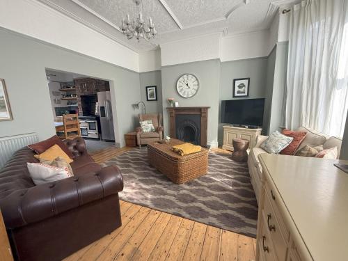 a living room with a couch and a tv at Victorian Villa close to Liverpool City Centre in Liverpool
